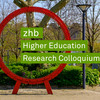 Photo of the red gear wheel on Martin-Schmeißer-Platz at TU Dortmund University. The lettering zhb Higher Education Research Colloquium protrudes from the gear wheel from left to right