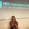 Laura Wuttke steht vor dem Schriftzug der HCI International 2023