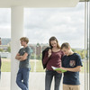 Students are talking in front of a large window