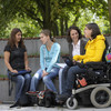 Students with handicap are sitting together on campus.